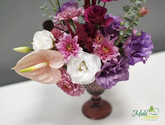 Composition in a glass with eustoma, chrysanthemum, anthurium, and eucalyptus photo